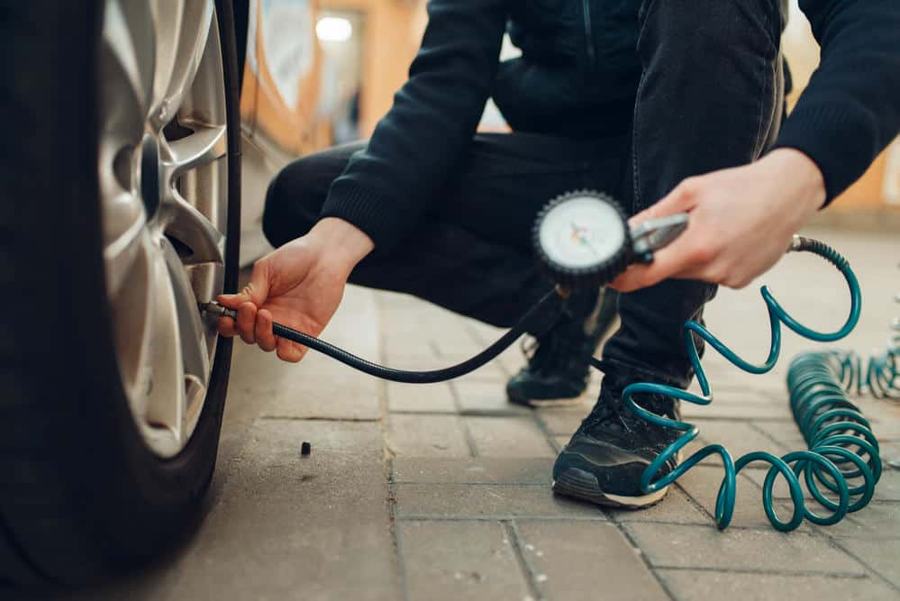 Mechanic checking tire pressure and balance at Dallas Complete Auto in Lancaster, Dallas, TX